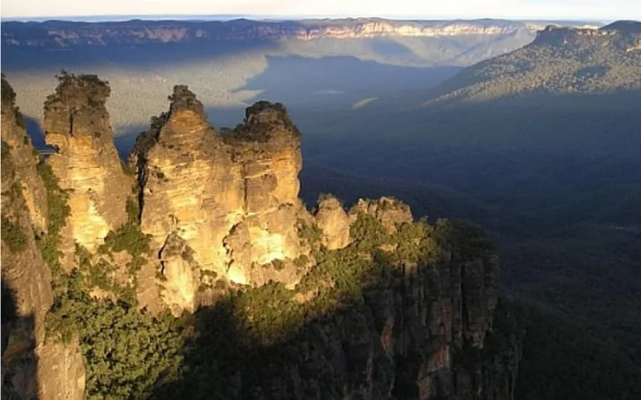The Three Sisters lit gold in late afternoon light