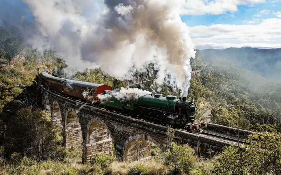 A steam train crossing a stone bridge in the Blue Mountains